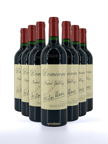 Row of Dominus Napa Valley wine bottles on a white background
